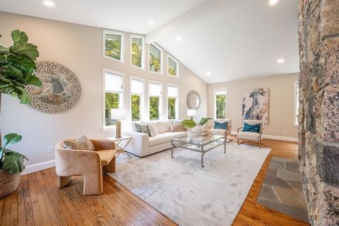 Entering this exquisite home, you are greeted by a grand double-height entryway that bathes the space in natural light, creating a warm & inviting atmosphere. The sunken living room boasts tall windows & dual-sided fireplace shared w/formal dining ro...