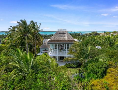 Situated on a desirable ridge with amazing elevation, this charming Bahamian style home has a rare, highly coveted view of both the ocean and the bay. Located less than 500 ft. from the beautiful Pink Sand Beach, Villa Iridescence includes two separa...