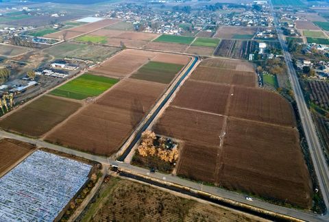 Almost 40 Acres of cropland in Fresno County separated by Dry Creek Canal. 2 parcels; 19.55 and 18.80 Acres respectively. Corner property with a huge potential for future growth.