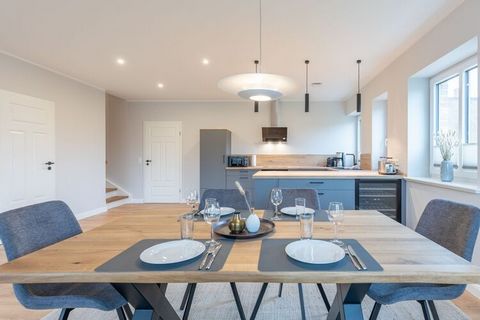 This newly built holiday home can accommodate up to five people. The semi-detached house is modern and exclusively furnished and offers everything you need for your stay. The spacious living area invites you with a beautiful sofa area (sofa bed) to c...