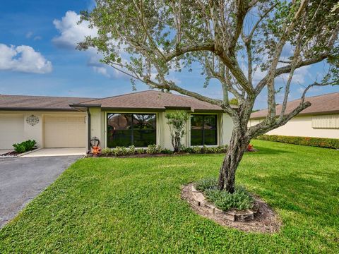 Fantastic Location! This home features a spacious front yard and an extended driveway. Located directly across from the clubhouse and pool, you'll enjoy easy access to amenities. The property boasts new windows and hurricane shutters, tile floors thr...