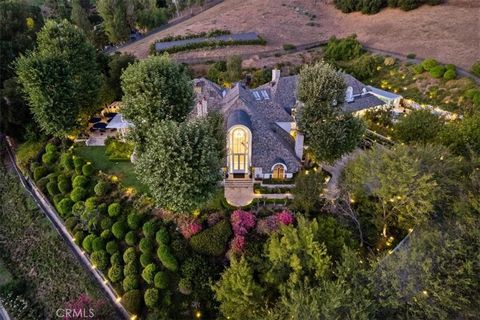 THE VERDANT ESTATE: Secluded Luxury Awaits. This privately gated French Country estate set within the exclusive North Ranch Country Club Estates exudes elegance and style. The 3.04-acre gated property with a long driveway leading to a dramatic entran...