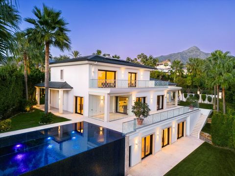 Step into the epitome of luxury with this frontline golf villa in the heart of Nueva Andalucia Positioned on a generous corner plot the property offers stunning views of the golf course and La Concha mountain Surrounded by lush greenery it provides a...