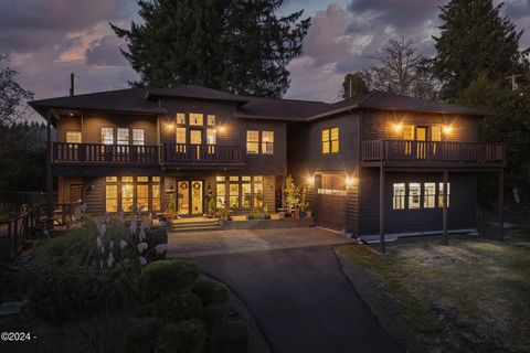 Sophisticated Coastal Living Awaits.Discover the perfect blend of modern luxury and coastal charm in this stunning contemporary home overlooking Devils Lake. Set on a serene .58-acre lot with fruit trees and ample space for an expansive garden, this ...