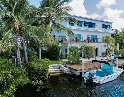 Paradise found! Experience the Ultimate in Coastal Living! Privacy abounds in this beautifully updated and lushly land-scaped Lake Front home with bay views from the top floor primary suite. Quick access from the lake to the bay and also to the ocean...