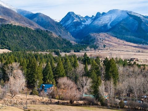 On the banks of Deep Creek, tucked into highly desired Paradise Valley, Montana lies this extraordinary property. This haven's eclectic farmhouse and medley of outbuildings embody history & rustic charm. The sunny & gracious living room has a firepla...