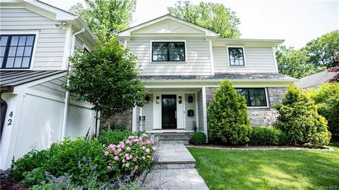 Nestled in the heart of Scarsdale in Fox Meadow you will find this beautifully renovated Split-Level home situated on a quiet, private lot. From the moment you arrive, pride of ownership is evident through the meticulously landscaped grounds and blue...