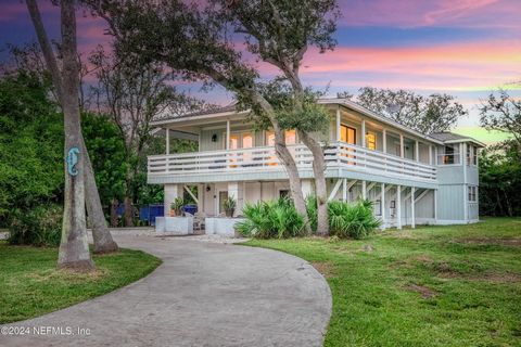 This versatile 4-bedroom, 2-bathroom + Office home is an ideal vacation retreat with excellent potential for short-term rentals, ideally situated just 4 lots away from the tranquil intracoastal waterway, its location is truly enviable. The upper leve...