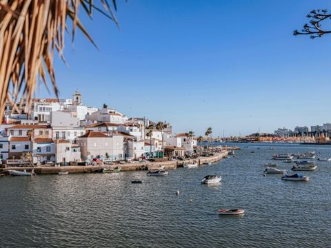 Located on one of the most picturesque streets in the Algarve, adorned with bougainvillea trees draping over the walkway, and just a short stroll away from the beach, dining spots, and shops, lies this modern two-bedroom townhouse. The ground floor c...