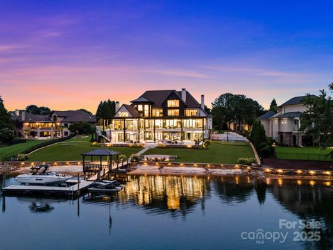 Experience the pinnacle of Lake Norman living from this extraordinary lakefront estate. Nestled just outside The Peninsula Club within the exclusive gated enclave of Connor Quay, The Legacy House marries coastal modern design with unparalleled sereni...