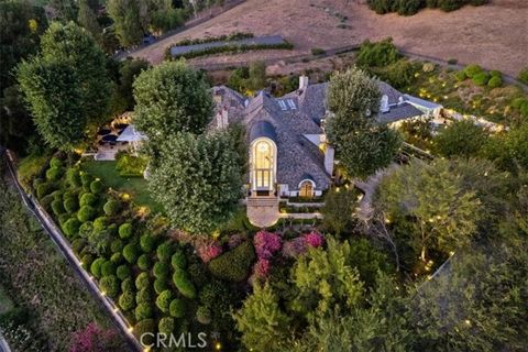 THE VERDANT ESTATE: Secluded Luxury Awaits. This privately gated French Country estate set within the exclusive North Ranch Country Club Estates exudes elegance and style. The 3.04-acre gated property with a long driveway leading to a dramatic entran...