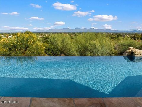 Nestled on the east side of Mummy Mountain, this private cul-de-sac property offers the most incredible city light and stunning mountain views of the McDowell Mountains and Pinnacle Peak! Enjoy the best of Arizona's Indoor/Outdoor Living with your am...