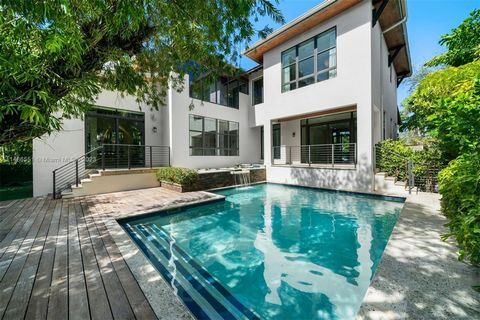 Enjoy living in this private oasis on the exclusive island of Key Biscayne. This 5 BD, 5.5 BA residence offers 4,871 SF of modern elegance. Upon entry, one is greeted by double-height ceilings and exposed wood beams. The open floor plan features terr...