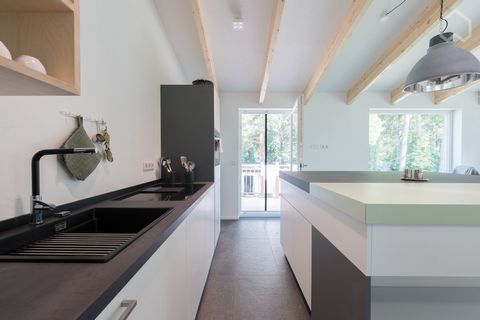 Newly built, bright apartment with exposed beams and high quality modern furnishings. The kitchen is fully equipped with appliances, cutlery and crockery, as well as a large island with plenty of storage space. The special feature here is the space f...