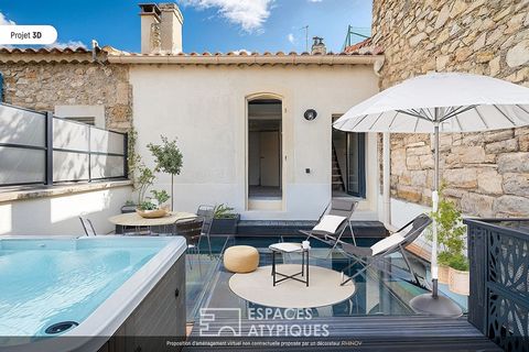 Located in the village of Mouriès, this 120 m2 townhouse has been completely redesigned with a glass terrace at its heart. The renovation is the result of the reunification of two houses dating from the 18th century and now connected by a glass ceili...