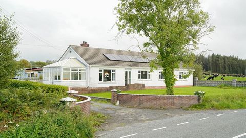 Fine & Country West Wales are happy to present this delightful detached, freehold bungalow. The dwelling comprises four bedrooms, two bathrooms with over a third of an acre of land. Surrounded by rolling Welsh hills and situated between the picturesq...