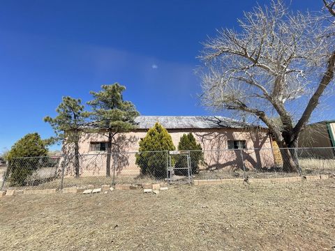 This 1475 SF Adobe & Cinder block home has a lot of potential for a fixer upper. 3 bedroom, 1 full bath, & dinning room. Custom wood burning fire place. Beautiful views of the Magdalena Mountains. 7100 SF of yard to landscape to your perfection. Fenc...