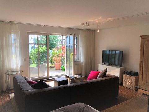 The lovely ground floor apartment with south-west terrace. The beautiful room offers a lot of space and is stylishly furnished. A new fitted kitchen and a bathroom with shower as well as a storage room, a cellar and a laundry room with its own washin...