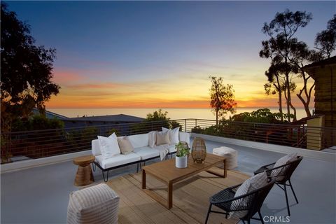 Embrace the allure of coastal elegance with this Victoria Beach architectural marvel, showcasing breathtaking views of Catalina Island, the coastline, and the ocean's white crests. This four-bedroom residence, accompanied by an office and four-and-on...
