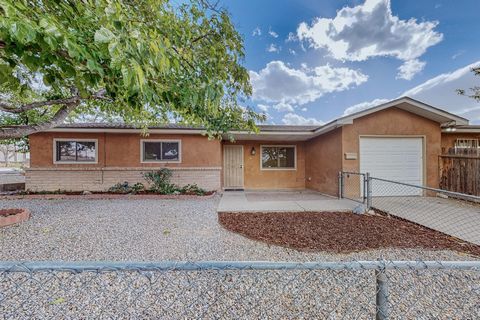 MULTI-GENERATION LIVING or RENTAL POSSIBILITIES. Located about a mile from Isotopes Park and UNM Sports Stadiums, this property consists of a 3 Bed, 2 Bath, main house with an attached garage PLUS an attached 2 Bed, 2 Bath Apartment with a separate a...